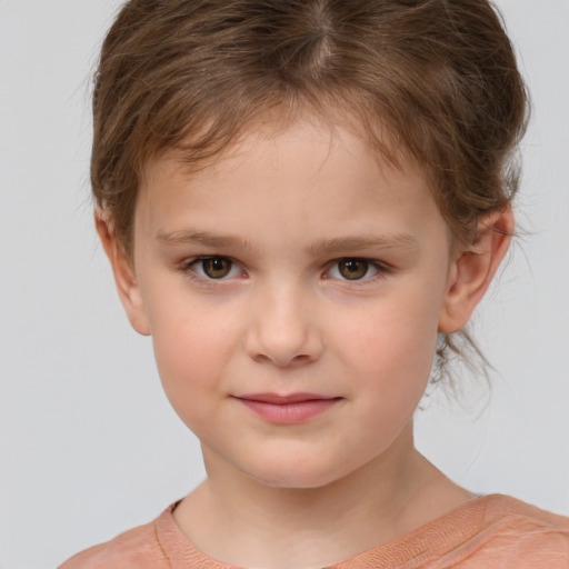 Joyful white child female with short  brown hair and brown eyes