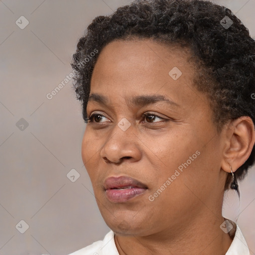 Joyful black adult female with short  brown hair and brown eyes