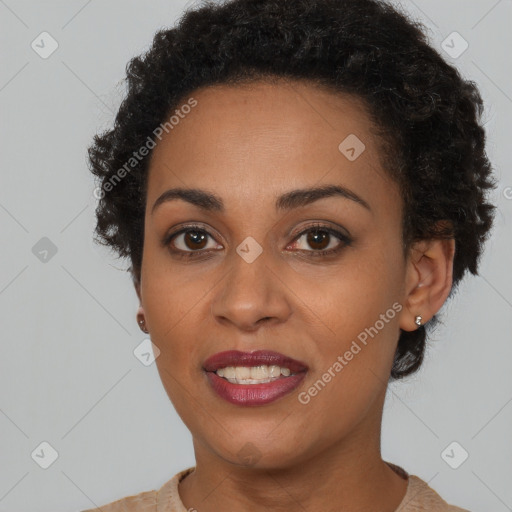 Joyful black young-adult female with short  brown hair and brown eyes