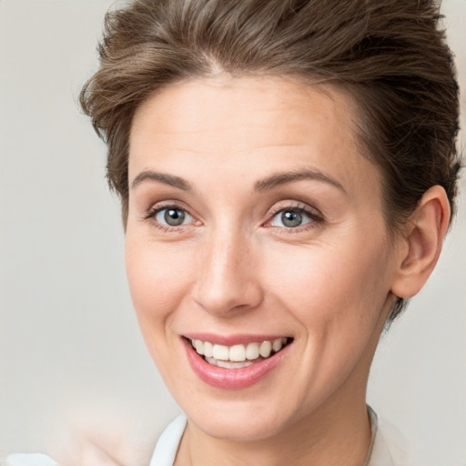 Joyful white young-adult female with short  brown hair and grey eyes