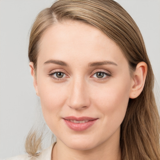 Joyful white young-adult female with long  brown hair and blue eyes