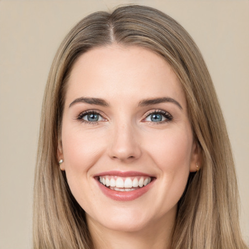 Joyful white young-adult female with long  brown hair and green eyes