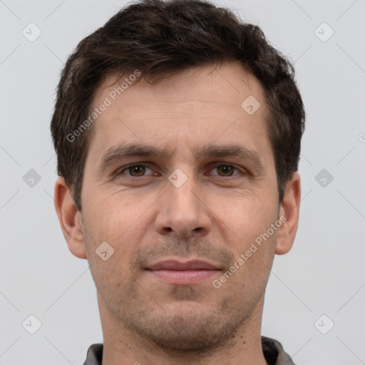 Joyful white adult male with short  brown hair and brown eyes