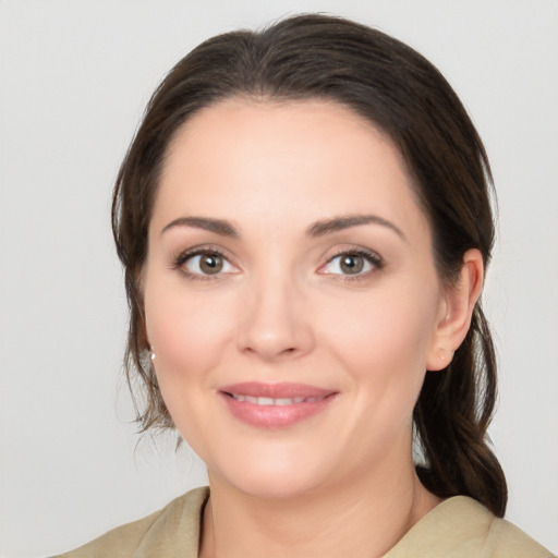 Joyful white young-adult female with medium  brown hair and brown eyes