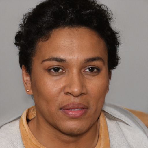 Joyful latino adult female with short  brown hair and brown eyes
