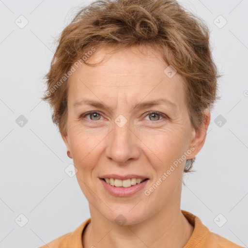 Joyful white adult female with short  brown hair and grey eyes