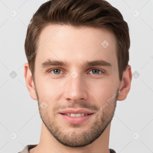 Joyful white young-adult male with short  brown hair and grey eyes