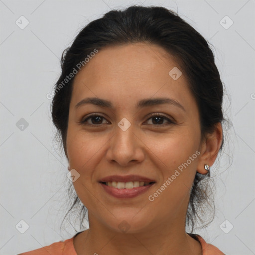 Joyful latino adult female with medium  brown hair and brown eyes