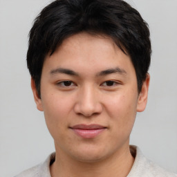 Joyful asian young-adult male with short  brown hair and brown eyes