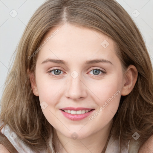 Joyful white young-adult female with long  brown hair and blue eyes