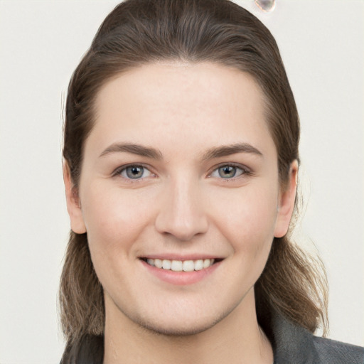 Joyful white young-adult female with long  brown hair and grey eyes