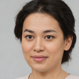 Joyful white young-adult female with medium  brown hair and brown eyes