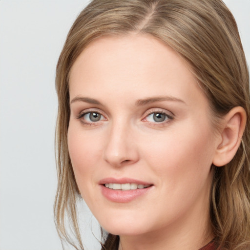 Joyful white young-adult female with long  brown hair and blue eyes