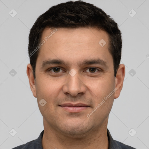 Joyful white young-adult male with short  black hair and brown eyes