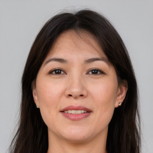 Joyful white adult female with long  brown hair and brown eyes
