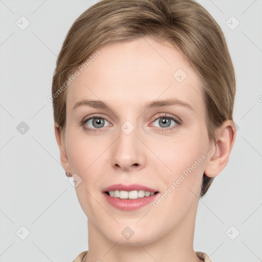 Joyful white young-adult female with short  brown hair and grey eyes