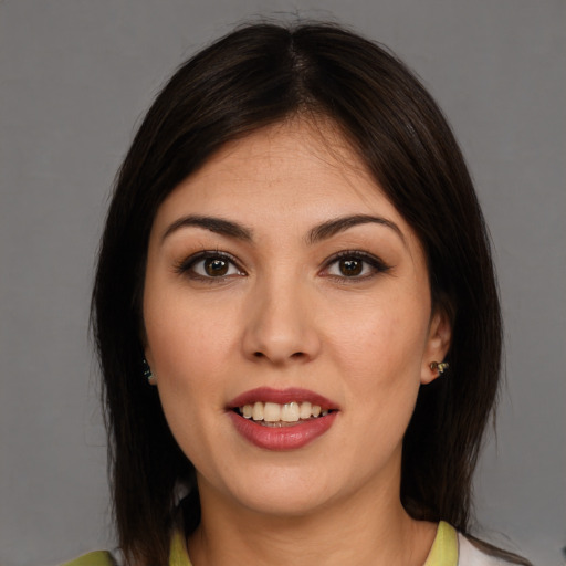 Joyful white young-adult female with medium  brown hair and brown eyes