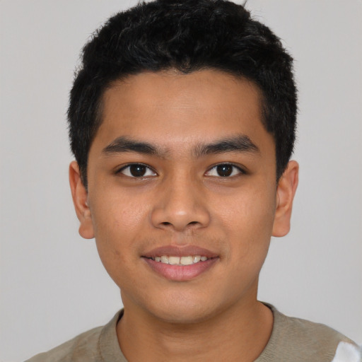 Joyful latino young-adult male with short  black hair and brown eyes