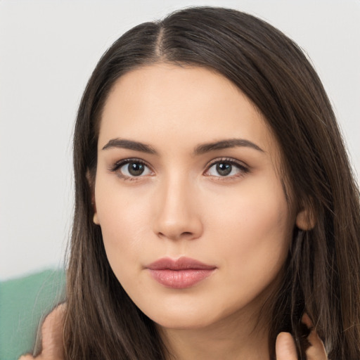 Neutral white young-adult female with long  brown hair and brown eyes