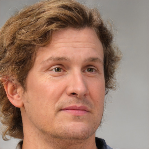 Joyful white adult male with medium  brown hair and grey eyes