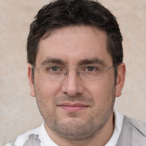 Joyful white adult male with short  brown hair and brown eyes