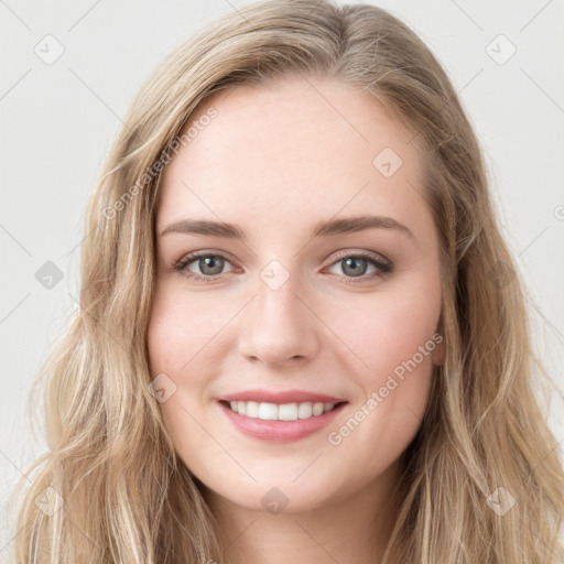 Joyful white young-adult female with long  brown hair and blue eyes