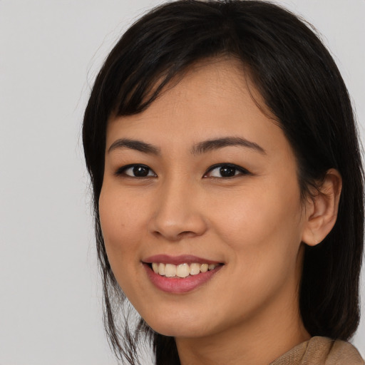 Joyful asian young-adult female with medium  black hair and brown eyes