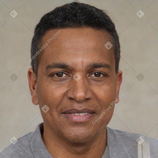 Joyful black adult male with short  brown hair and brown eyes