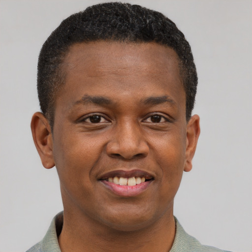 Joyful black young-adult male with short  brown hair and brown eyes