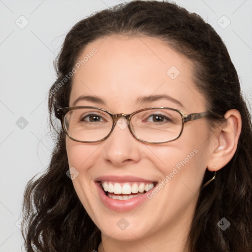 Joyful white adult female with long  brown hair and brown eyes