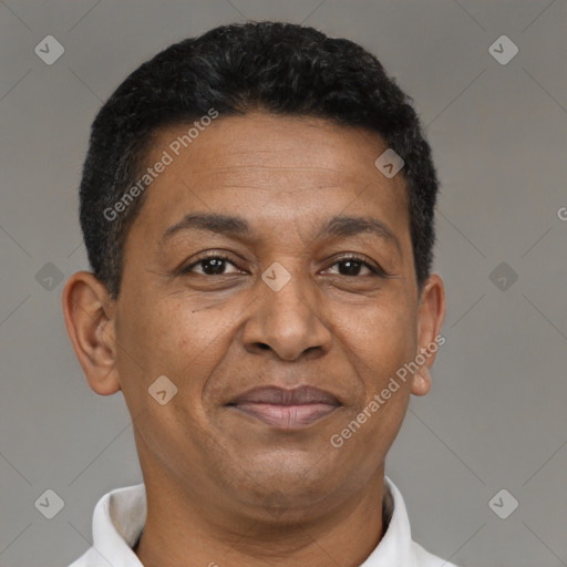 Joyful latino adult male with short  brown hair and brown eyes