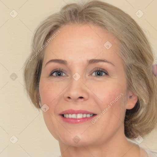 Joyful white adult female with medium  brown hair and blue eyes