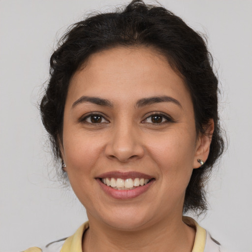 Joyful latino young-adult female with medium  brown hair and brown eyes