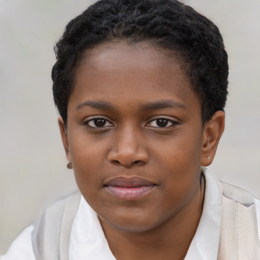 Joyful black child female with short  brown hair and brown eyes