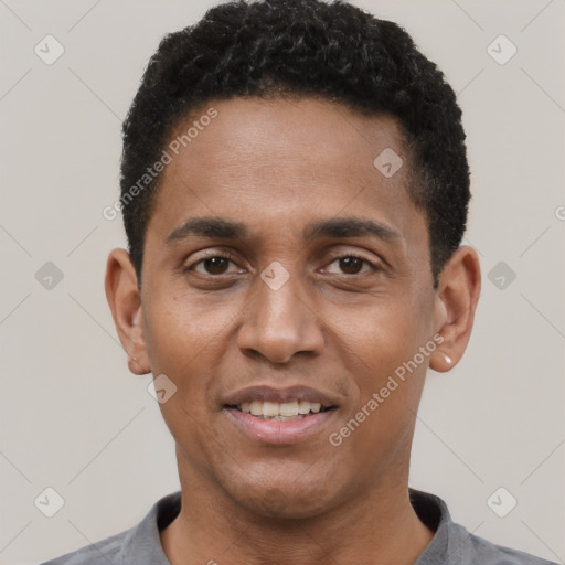 Joyful black young-adult male with short  black hair and brown eyes