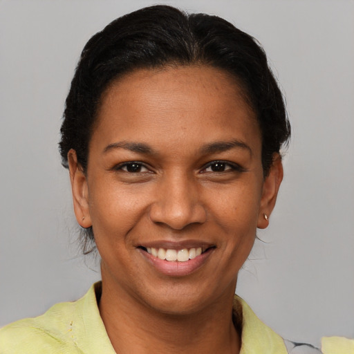 Joyful latino young-adult female with short  brown hair and brown eyes