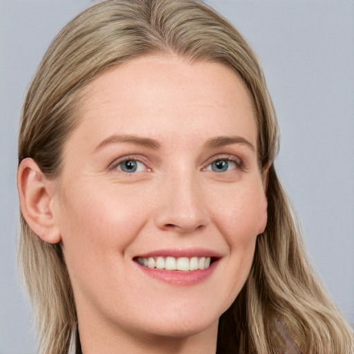 Joyful white young-adult female with long  brown hair and blue eyes