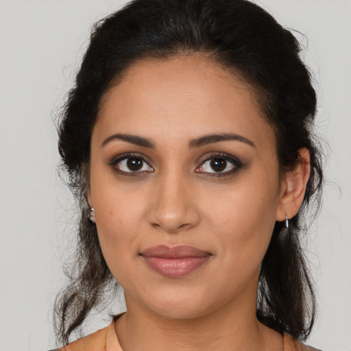 Joyful latino young-adult female with long  brown hair and brown eyes