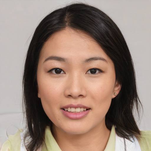 Joyful asian young-adult female with medium  brown hair and brown eyes