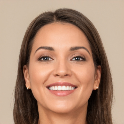 Joyful white young-adult female with long  brown hair and brown eyes