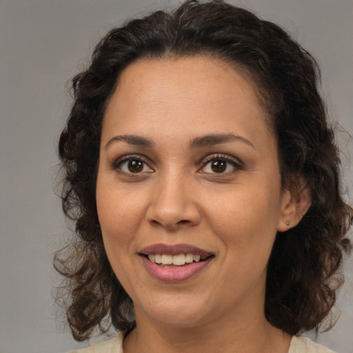 Joyful white adult female with medium  brown hair and brown eyes
