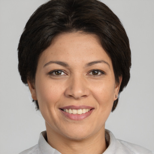 Joyful white adult female with short  brown hair and brown eyes