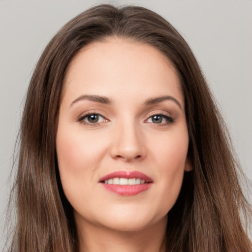 Joyful white young-adult female with long  brown hair and brown eyes