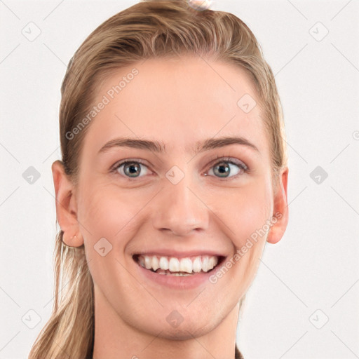 Joyful white young-adult female with long  brown hair and blue eyes