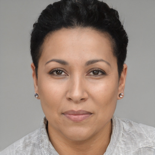 Joyful latino adult female with short  black hair and brown eyes