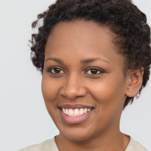 Joyful black young-adult female with short  brown hair and brown eyes