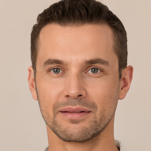 Joyful white young-adult male with short  brown hair and brown eyes