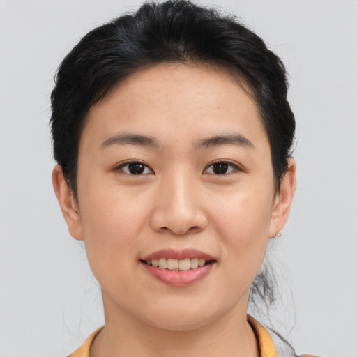 Joyful asian young-adult female with short  brown hair and brown eyes