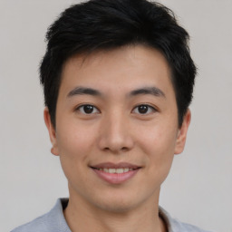 Joyful asian young-adult male with short  black hair and brown eyes