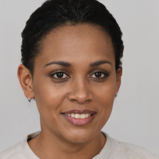 Joyful black young-adult female with short  brown hair and brown eyes